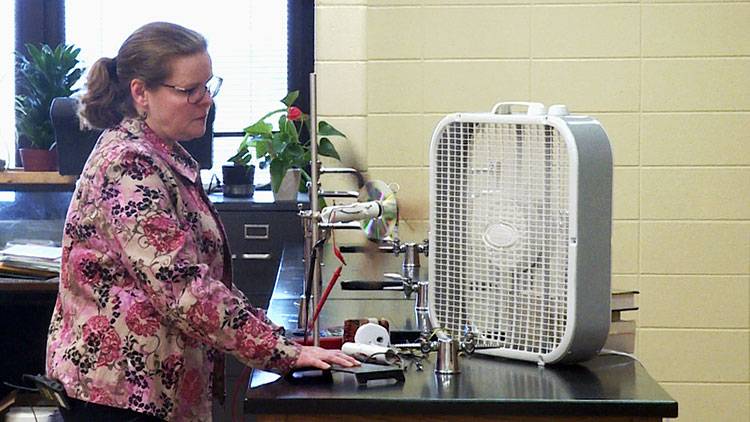 Martha Bowman of Tri-North Middle School in Bloomington demonstrates a project she does with her students that shows how a wind turbine generates electricity. 