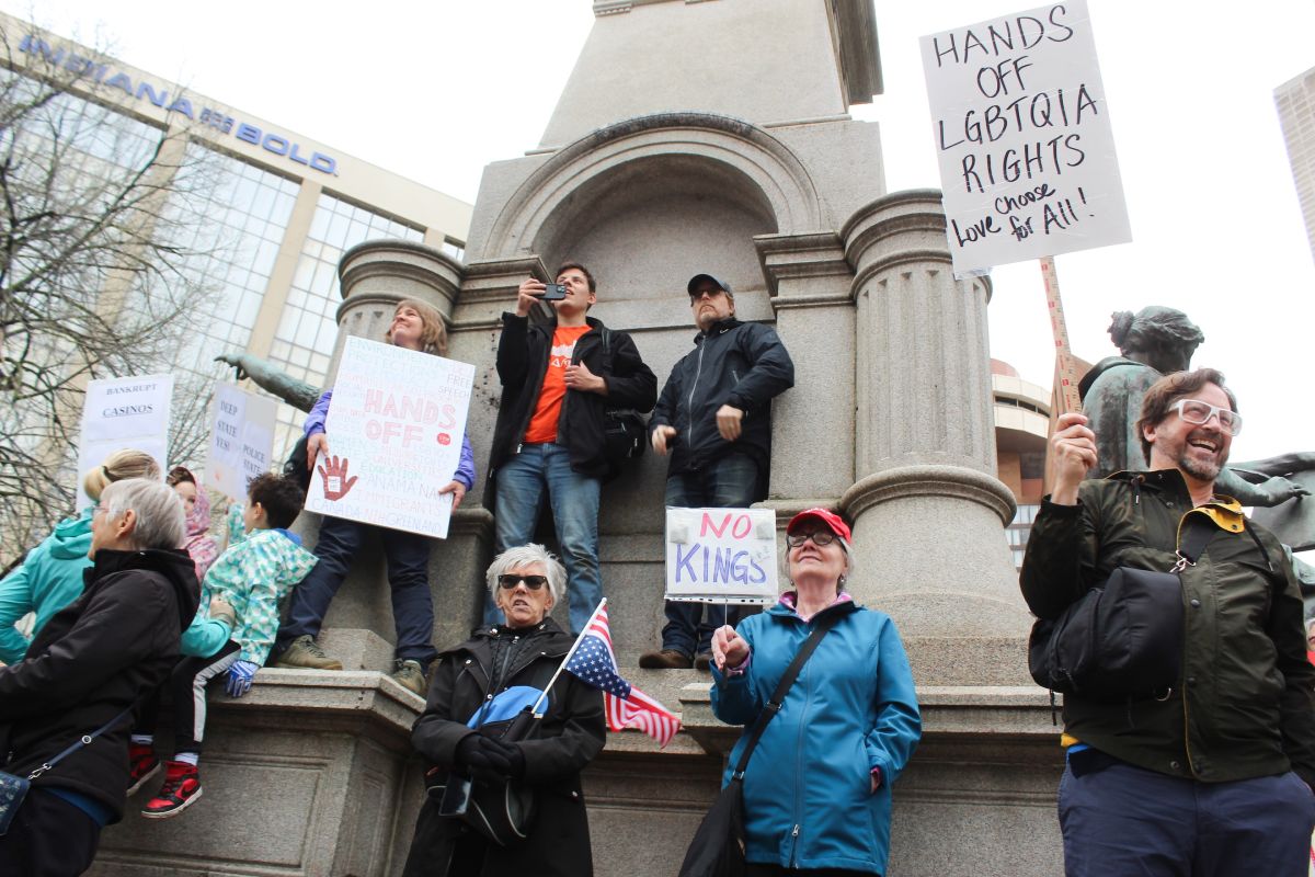 Protestors stand outside the Indiana Statehouse on Saturday, April 5 protesting against President Trump and his policies. The protest drew hundreds to Indianapolis, and thousands throughout the U.S.