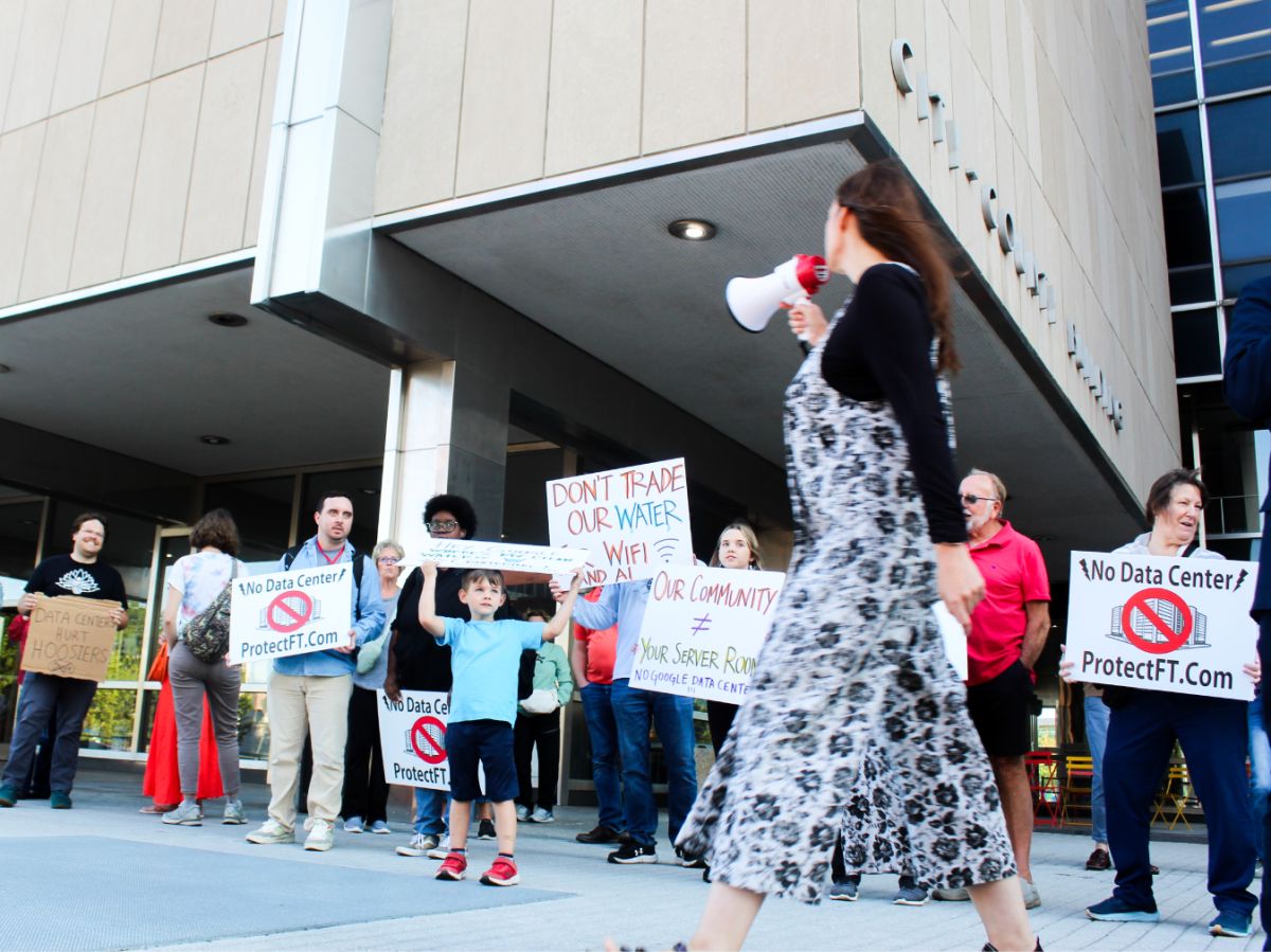 Meredith Sharp, who organizes against the data center with the community group “Protect Franklin Township,” chants into a megaphone outside the City-County Building on Sept. 8, 2025.