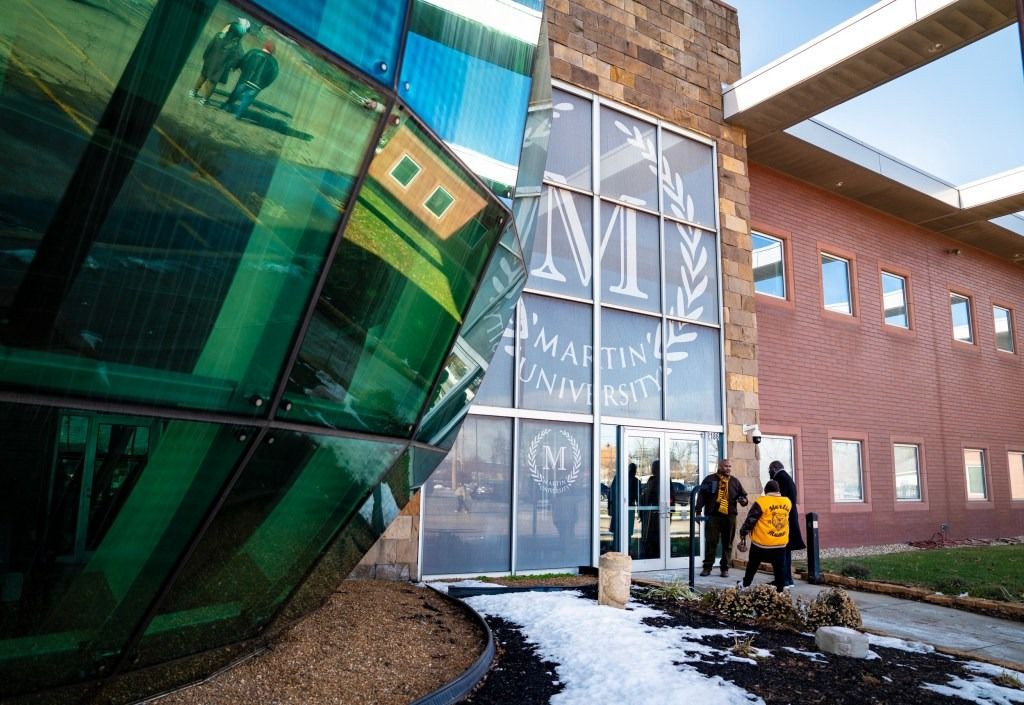 Dwight McGill (left), president of the Martin University Alumni Association, talks with others who attended a press conference Dec. 17, 2025, at Martin University in Indianapolis. During his talk, McGill called for the resignation of Joseph Perkins, the chairman of the university’s board of trustees.