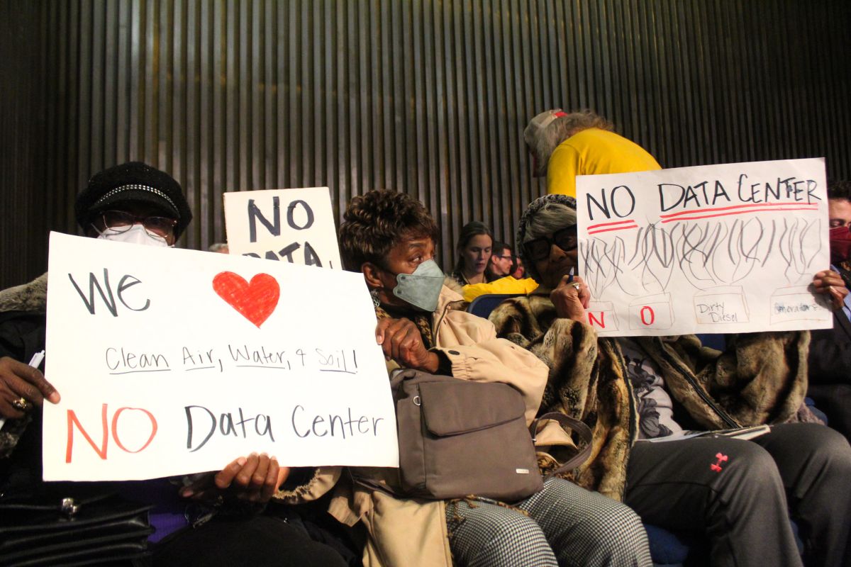 Residents hold signs in opposition to the proposed Martindale-Brightwood data center before the hearing examiner’s recommendation was delayed for a month. Many people showed up to protest the proposed data center in the Martindale-Brightwood neighborhood in Indianapolis. 