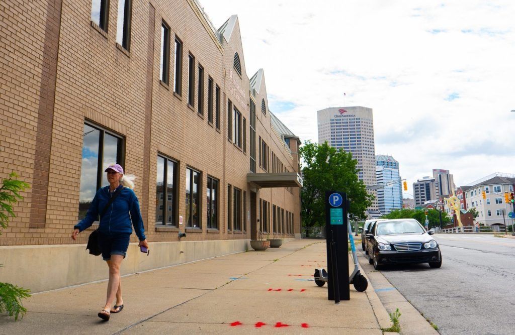 A pedestrian passes parking meters July 10, 2024, on Indiana Avenue in downtown Indianapolis.