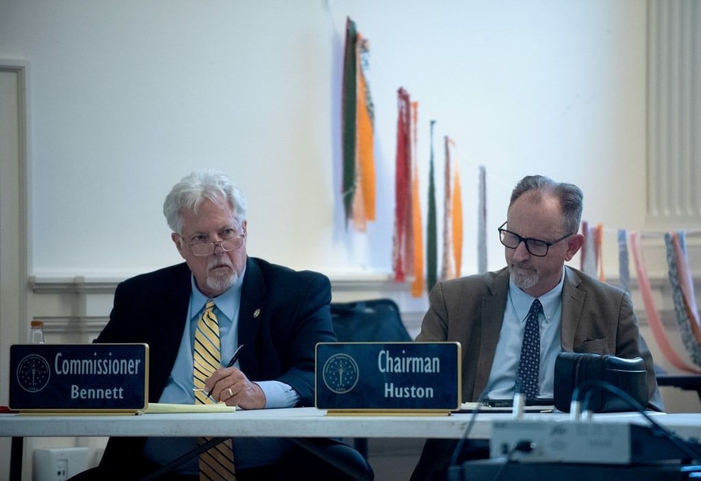 Indiana Utility Regulatory Commissioner Wesley Bennett (left) and chairman Jim Huston listen to testimony from the public Aug. 21, 2025, during a field hearing concerning AES utility rates, at Southeast Community Services in Indianapolis. 