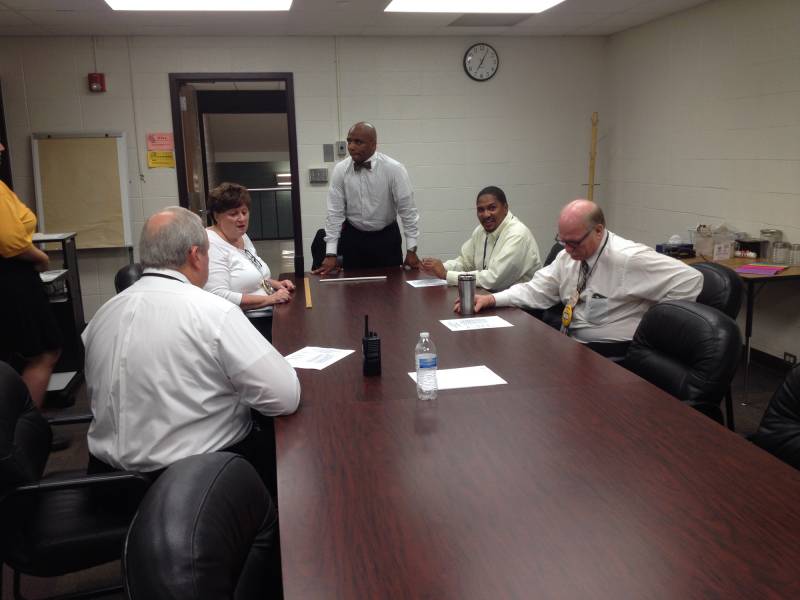 Arlington Principal Stan Law makes a few last comments to other administrators minutes before Arlington High School opens for class on the first day of the 2015-16 school year, Monday, August 3, 2015. | By Eric Weddle/WFYI News