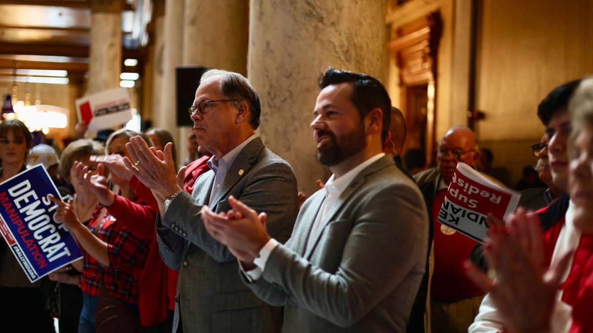 Gov. Mike Braun and Lt. Gov. Micah Beckwith clap during a pro-redistricting rally in the Indiana Statehouse rotunda on Friday, Dec. 5, 2025. 