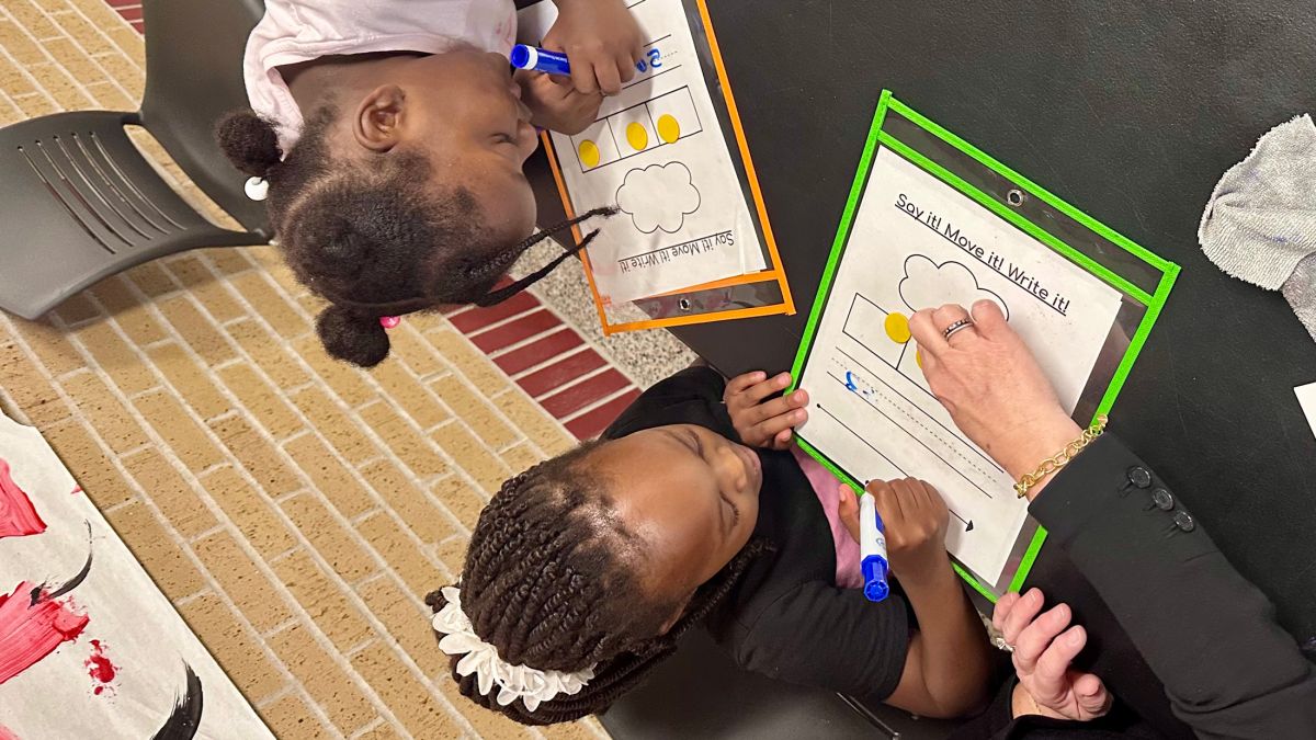 Bridget Kennedy, lead tutor at Pleasant Run Elementary School, leads two students through a phonemic awareness exercise on Wednesday, May 14, 2025. 