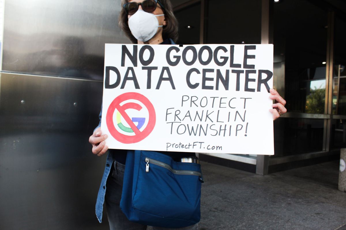 A Franklin Township resident stands outside the Indianapolis City-County Council building protesting Google's proposed data center campus on the south side of the city.