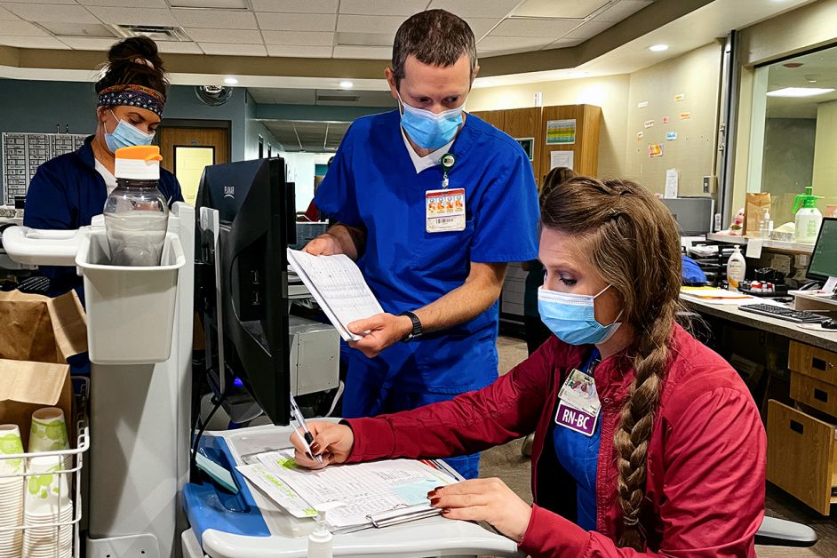 Nurses Matt Ippel and Kelsey Coffin review cases at Pine Rest Christian Mental Health Services. The Grand Rapids facility treats children and adults with mental health issues.