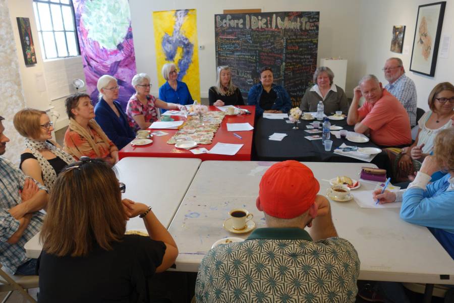 People discuss end-of-life planning at a death cafe in the Stutz Art Gallery.