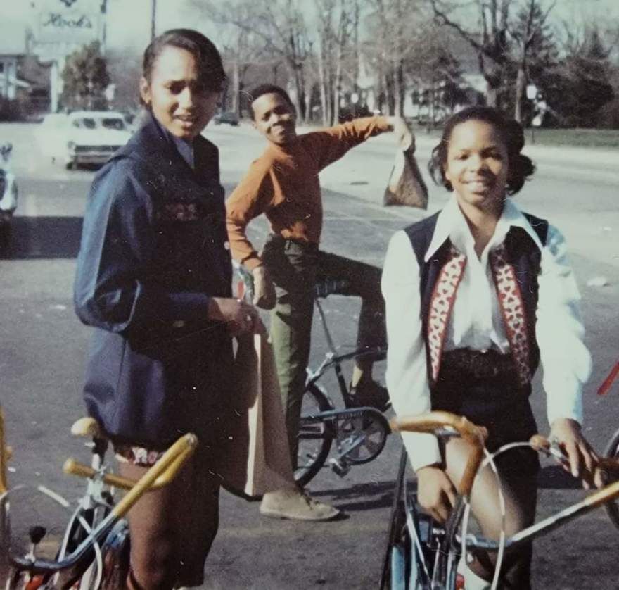 Sabae Martin (left) and her friends photographed in 1971 in front of a grocery store that used to be across from Tarkington Park. In the background, there is a sign for a drugstore, which is also no longer open.