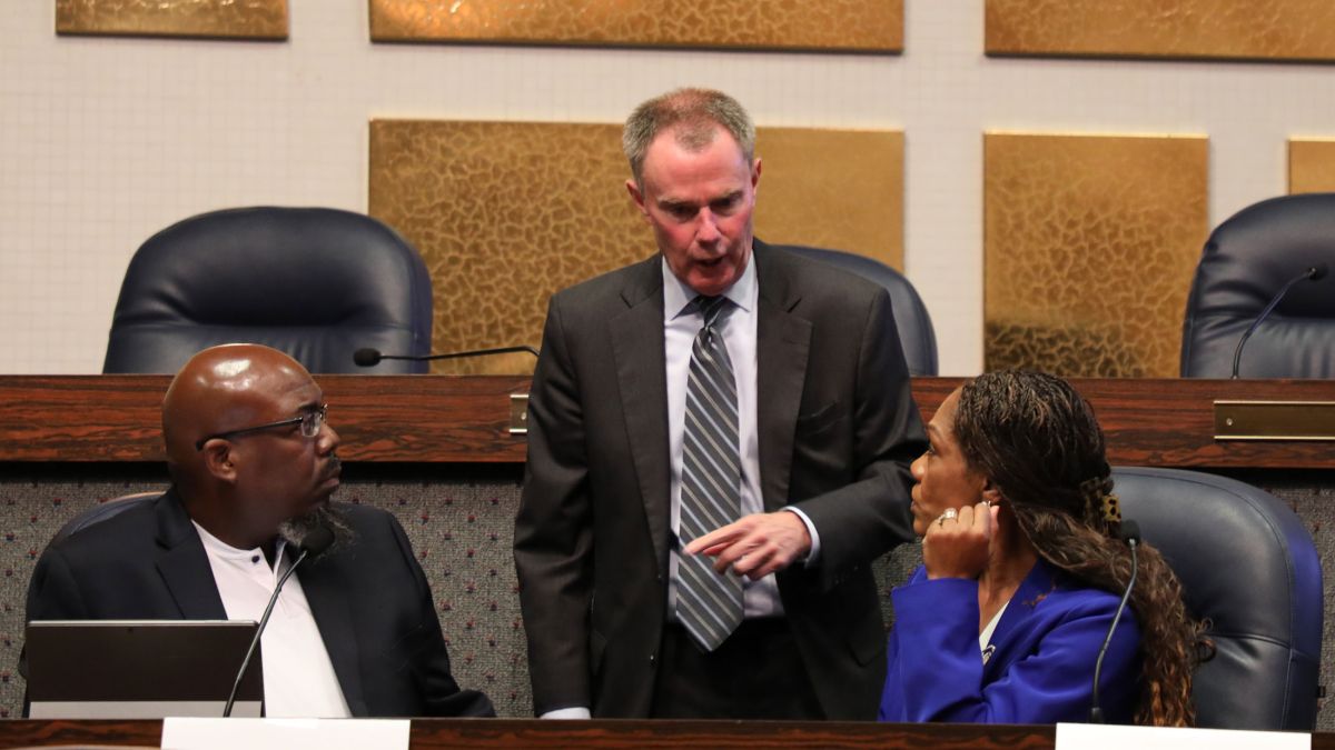 Mayor Joe Hogsett talks to Barato Britt, President of Edna Martin Christian Center, and Maggie Lewis, Majority Leader of the Indianapolis City-County Council during the first meeting of the Indianapolis Local Education Alliance on Wednesday, June 25, 2025 at the City-County Building. (Eric Weddle / WFYI)