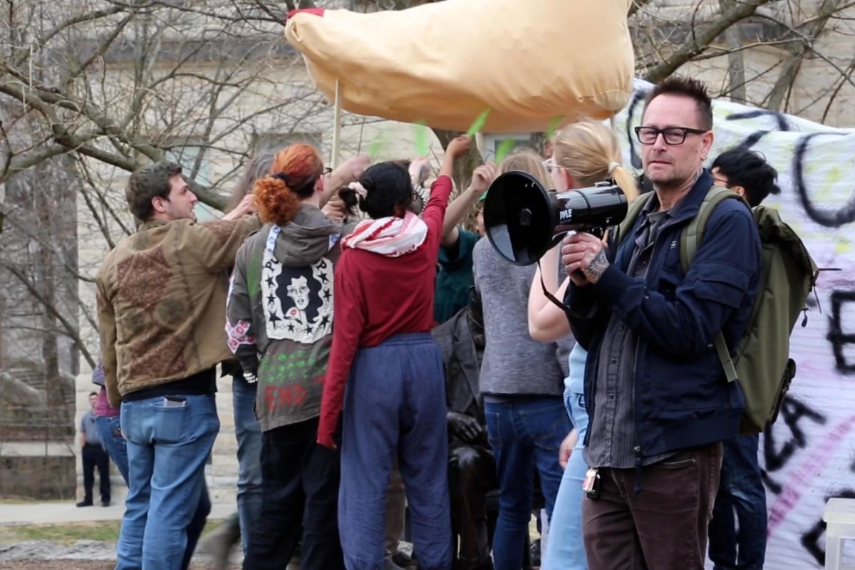 At a Day of Action protest in February 2024, demonstrators created a giant paper mâché foot to represent IU and the statehouse treading on academic freedom. They tickled it away with green feathers.
