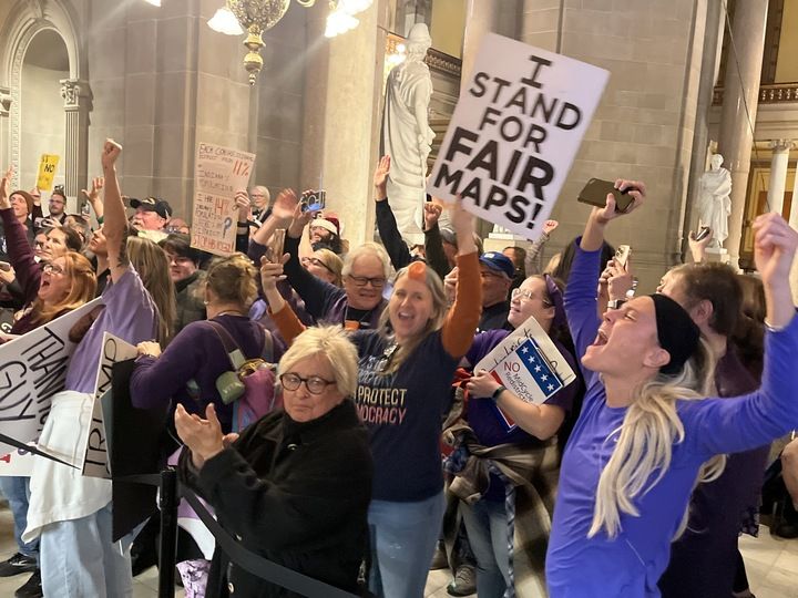 Protesters celebrate outside the Indiana Senate chamber when a redistricting bill is defeated on Dec. 11, 2025.