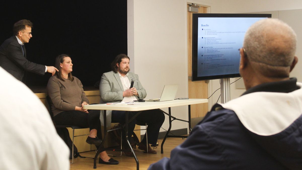 Hope Martin, a design manager for Metrobloks, center, listens to residents during a community meeting at Douglass Park Family Center Monday, Feb. 2, 2025. Indianapolis attorneys Bradley Sugarman, left, and Tyler Ochs, right, are working with Metrobloks.
