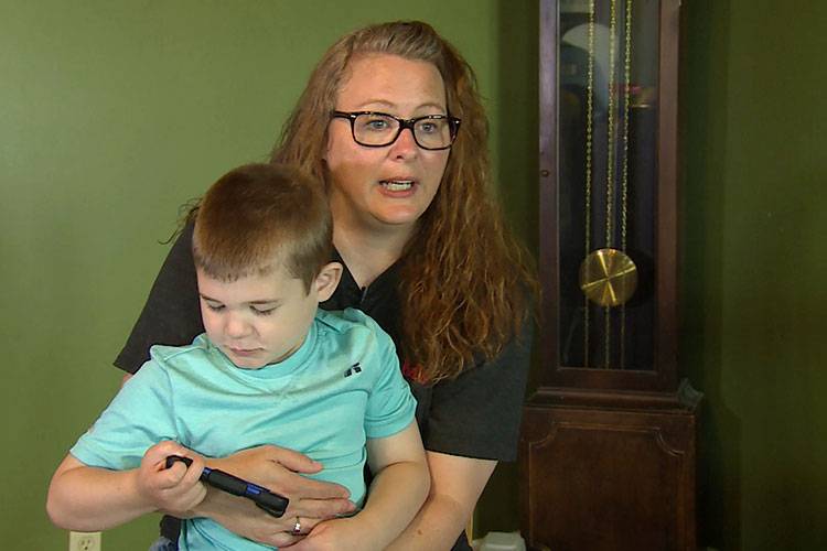 Miriah Mershon holds her 7 year-old son Jameson. Mershon says her family has done a lot to help prevent Jameson's seizures, including cutting down trees in her front yard.