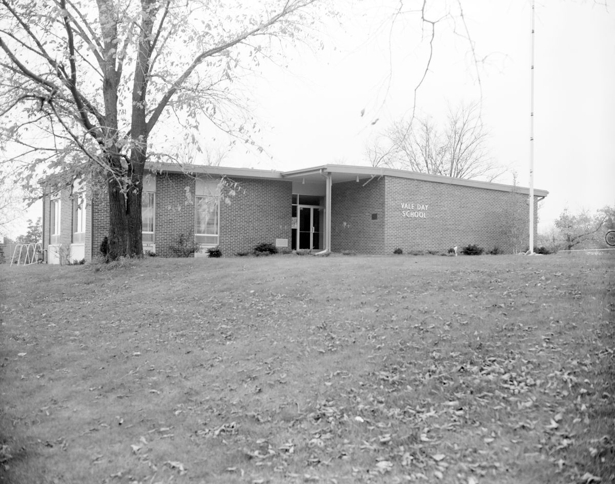 Black and white photo of a small brick building.