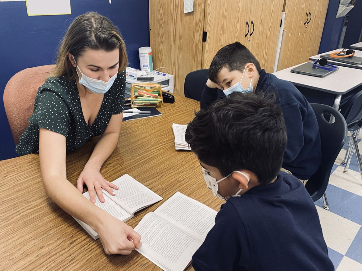 A teaches works on guided reading with students at Victory College Prep in Indianapolis last month.