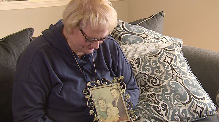 Kathleen Anderson holds a picture of her adoptive parents. She hopes to learn more about her birth mother through an Indiana law that went into effect over the summer. - Steve Burns, WFIU/WTIU News