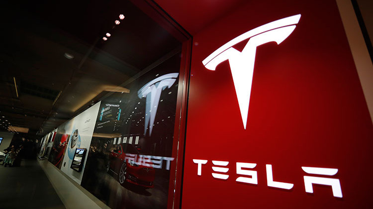 FILE - This Feb. 9, 2019, file photo shows a sign bearing the company logo outside a Tesla store in Cherry Creek Mall in Denver. The U.S. government's road safety agency is sending a special team to Indiana to investigate a fatal crash involving a Tesla electric vehicle. - AP Photo/David Zalubowski, File