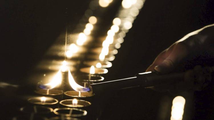 A candle is lit at a ceremony marking the International Holocaust Remembrance Day in the Jewish Museum and Tolerance Center in Moscow, Russia, Friday, Jan. 27, 2017. (Pavel Golovkin/AP)