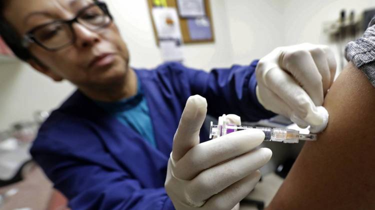 In this Thursday, Jan. 11, 2018 file photo, Ana Martinez, a medical assistant at the Sea Mar Community Health Center, gives a patient a flu shot in Seattle. This yearâ€™s U.S. flu season got off to an early start, and itâ€™s been driven by a nasty type of flu that tends to put more people in the hospital and cause more deaths than other common flu bugs. - AP Photo/Ted S. Warren