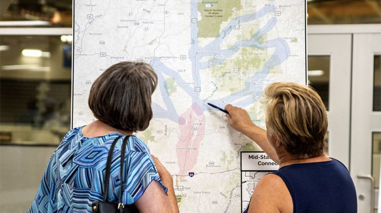 Atendees of a public meeting held in August 2019 look at a map of the Mid-States Corridor project. - FILE: Provided by Mid-States Corridor