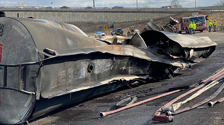 The wreckage of the semi that overturned and caught fire Thursday afternoon sits on the I-465 ramp to I-70 eastbound. - Indiana Department of Transportation via Twitter