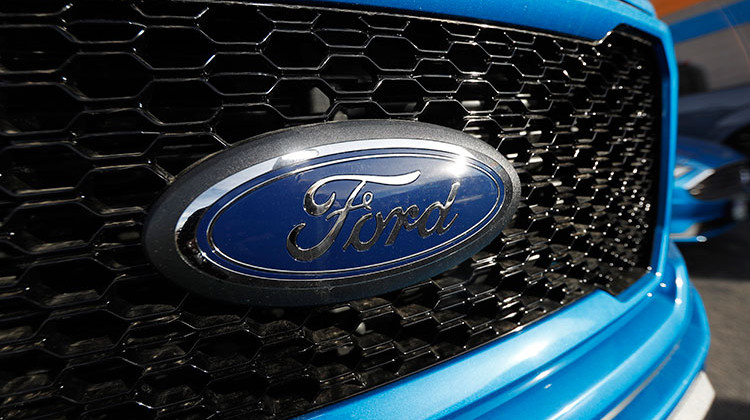 In this Sunday, Nov. 10, 2019, photograph, the company logo shines on the grille of an unsold 2020 F-150 pickup truck at a Ford dealership in Littleton, Colo. - AP Photo/David Zalubowski
