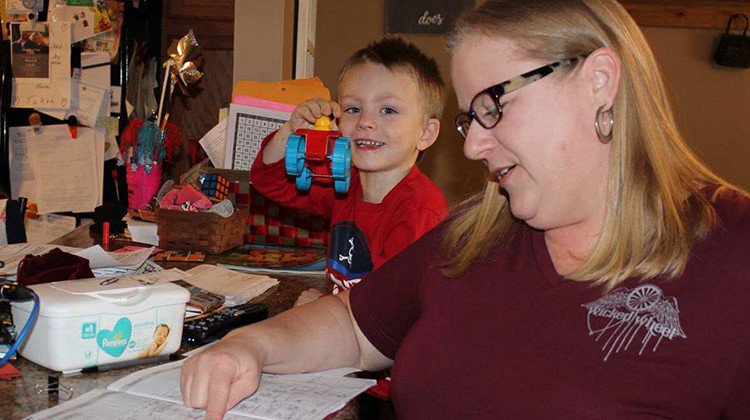 Rebecca Austin, a foster parent in Illinois, uses a calendar to keep track of all of her children's doctors appointments. - Christine Herman/Illinois Public Media