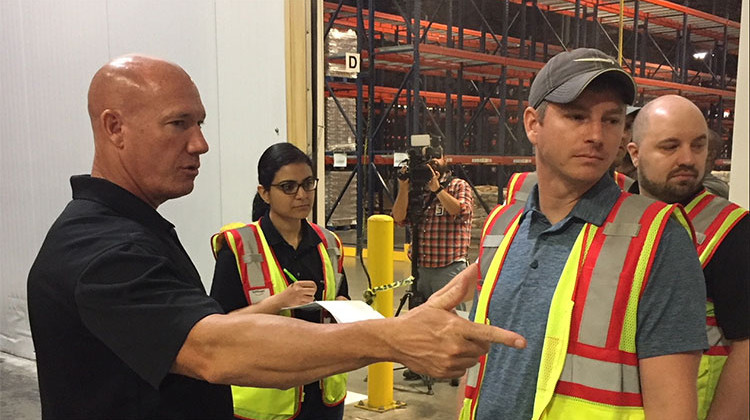 Gleaners COO and CFO Joe Slater (left) gives Amazon employees a tour of the freezer. - Jill Sheridan/IPB News