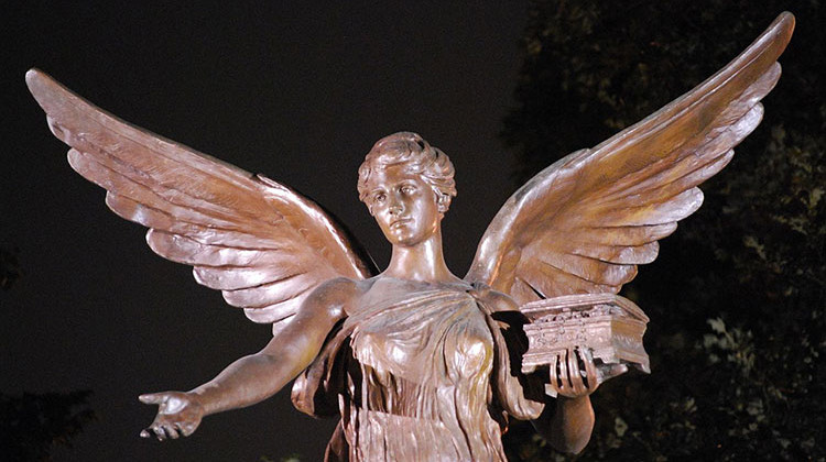 The statue of Beneficence at night on the campus of Ball State University. The school first started accepting student registrations on June 17, 1918. - Travisleehardin/CC-BY-SA-3.0