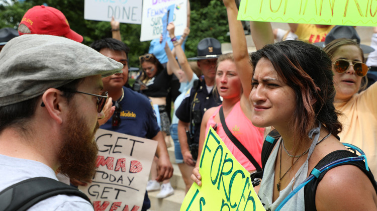 Thousands of people came to the Indiana Statehouse on Saturday, June 25, 2022 to advocate for abortion rights. Others also supported the U.S. Supreme Court's decision to end the constitutional protections for abortion. Two 28-year-olds, Melissa Eleonora Mena-Schneller, right, and Austin, left, debate whether a woman should have the choice to end a pregnancy.  - Eric Weddle/WFYI