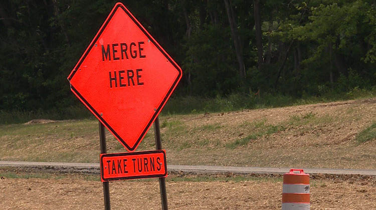 Signs along I-69 section 5 direct drivers to use both lanes during backups. - WFIU-WTIU News