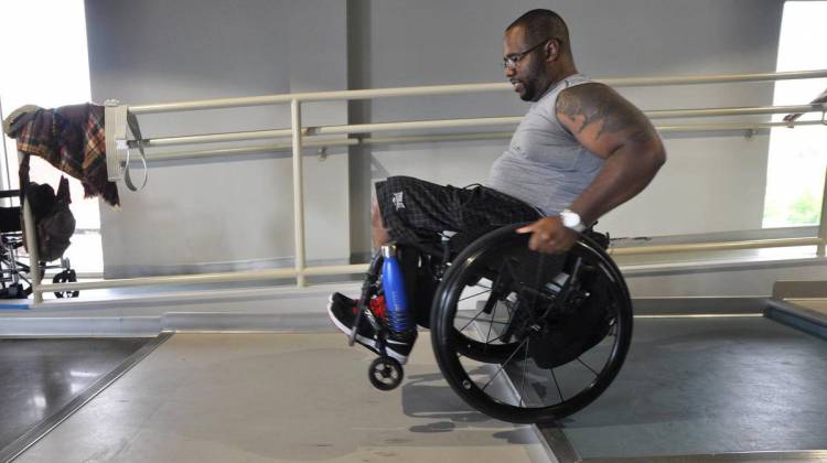 Aaron Murray pops a wheelie at the ParaQuad gym in St. Louis. - Durrie Bouscaren /Saint Louis Public Radio