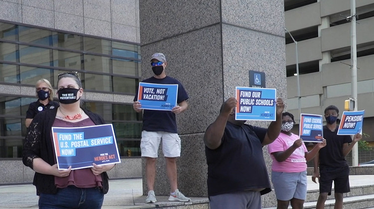 About15 people rallied, starting at Sen. Todd Young's office at 12:30 p.m. before moving to Sen. Mike Braun's office. - Alan Mbathi/IPB News