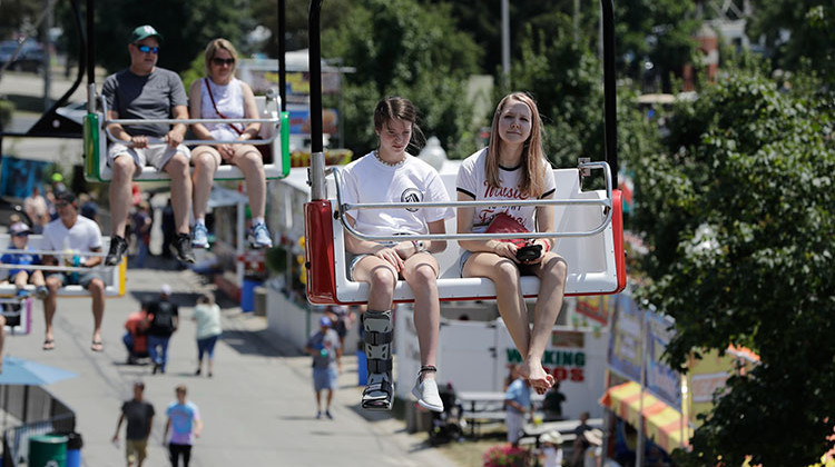 Guests ride on the "skyride" during the opening day of the Indiana State Fair, Friday, Aug. 2, 2019, in Indianapolis. The fair runs through Sunday, Aug. 18. - AP Photo/Darron Cummings