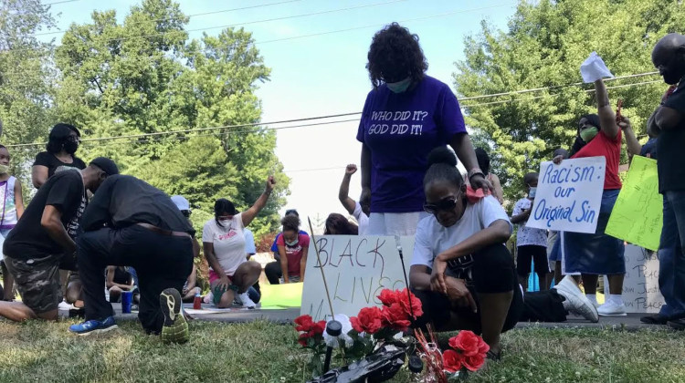 Tara Williams kneels over the site where her son, Malcolm Williams, was shot and killed by an Indiana State Police trooper at a protest in Jeffersonville, Indiana. - John Boyle / LPM