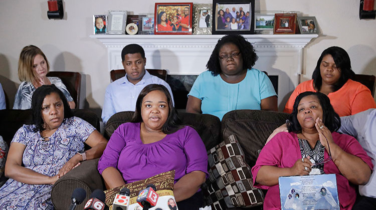 Tia Coleman, middle seated, speaks as she is surrounded by family members during a news conference at her Indianapolis home, Tuesday, Aug. 14, 2018. Seventeen people died when the boat sank during a July 19 storm near Branson, Missouri, including 40-year-old Glenn Coleman, 9-year-old Reece, 7-year-old Evan and 1-year-old Arya. Five other Coleman relatives also died. - AP Photo/Darron Cummings