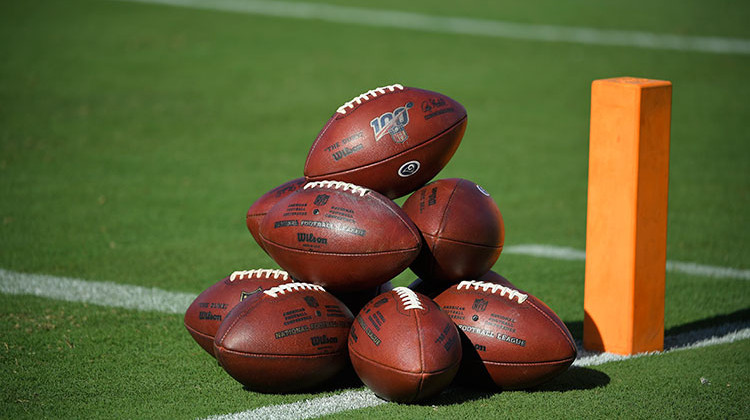 Fotballs are stacked up on the field before the start of an NFL preseason football game Saturday, Aug. 24, 2019, in Los Angeles. - AP Photo/Mark J. Terrill