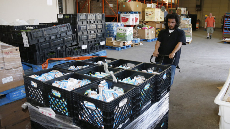 Joseph Elliote moves a pallet full of milk in the Jesus House homeless shelter warehouse in Oklahoma City. - AP Photo