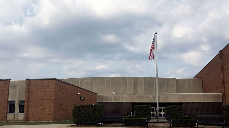 An American flag waves in front of Clay High School in South Bend. - Jennifer Weingart/WVPE Public Radio