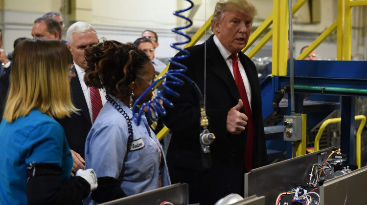 Then President-elect Donald Trump (right) and Vice President-elect Gov. Mike Pence visit the Carrier air conditioning and heating company in Indianapolis on Dec. 1, 2016. - Timothy A. Clary/AFP/Getty Images