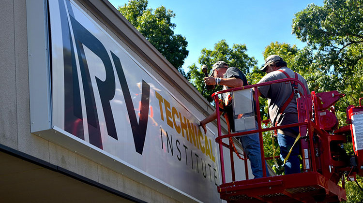 Workers put final touches on the front sign of the new RV Technical Institute in Elkhart.  - Justin Hicks/IPB News