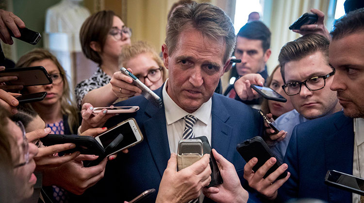 Sen. Jeff Flake, R-Ariz., center, speaks with reporters after meeting with Senate Majority Leader Mitch McConnell of Ky., in his office in the Capitol in Washington, Friday, Sept. 28, 2018. The Senate Judiciary Committee advanced Brett Kavanaugh's nomination for the Supreme Court after agreeing to a late call from Sen. Jeff Flake, R-Ariz., for a one week investigation into sexual assault allegations against the high court nominee.  - AP Photo/Andrew Harnik