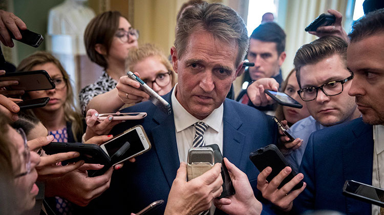 Sen. Jeff Flake, R-Ariz., center, speaks with reporters after meeting with Senate Majority Leader Mitch McConnell of Ky., in his office in the Capitol in Washington, Friday, Sept. 28, 2018. The Senate Judiciary Committee advanced Brett Kavanaugh's nomination for the Supreme Court after agreeing to a late call from Sen. Jeff Flake, R-Ariz., for a one week investigation into sexual assault allegations against the high court nominee. - AP Photo/Andrew Harnik