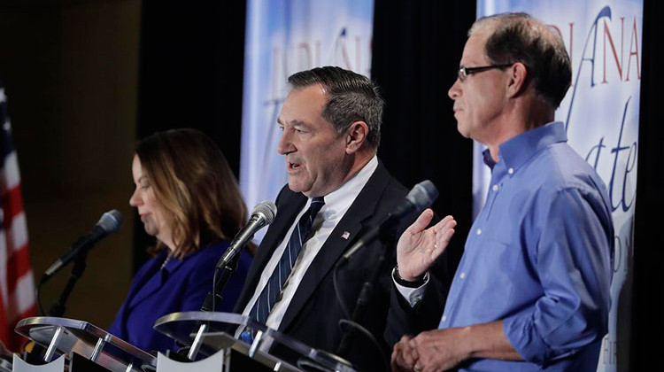 U.S. Sen. Joe Donnelly (D-Ind.), center, speaks during a U.S. Senate debate against Republican Mike Braun, right, and Libertarian Lucy Brenton, left. (Photo courtesy Indiana Debate Commission, Darron Cummings/AP) - Indiana Debate Commission, Darron Cummings/AP