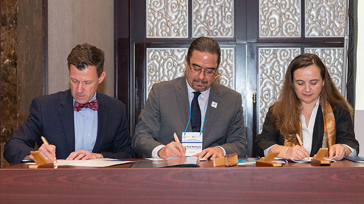 Rob Shumaker, president of the Indianapolis Zoological Society; Jon Paul Rodriguez, chair of the IUCN Species Survival Commission; and Grethel Aguilar, director general of the International Union for Conservation of Nature, sign the agreement to create the first Global Center for Species Survival. - Provided by the Indianapolis Zoo