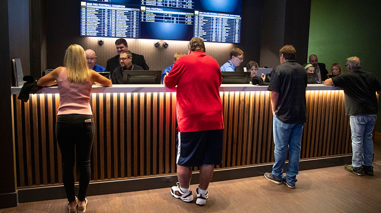 Betters line up to place wagers after sports betting became legal in Indiana at the Indiana Grand Racing & Casino in Shelbyville, Ind., Sunday, Sept. 1, 2019. - AP Photo/Michael Conroy