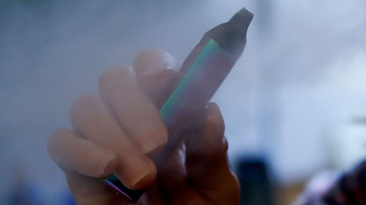 In this photo made on Friday, Oct. 4, 2019, a woman uses her vaping device in Harmony, Pa. - AP Photo/Keith Srakocic