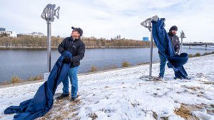 The artwork is along the White River Trail south of the west Michigan Street bridge on the west bank of the White River. - Provided by the University of Indianapolis